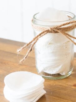makeup wipes in mason jar and on wood table.