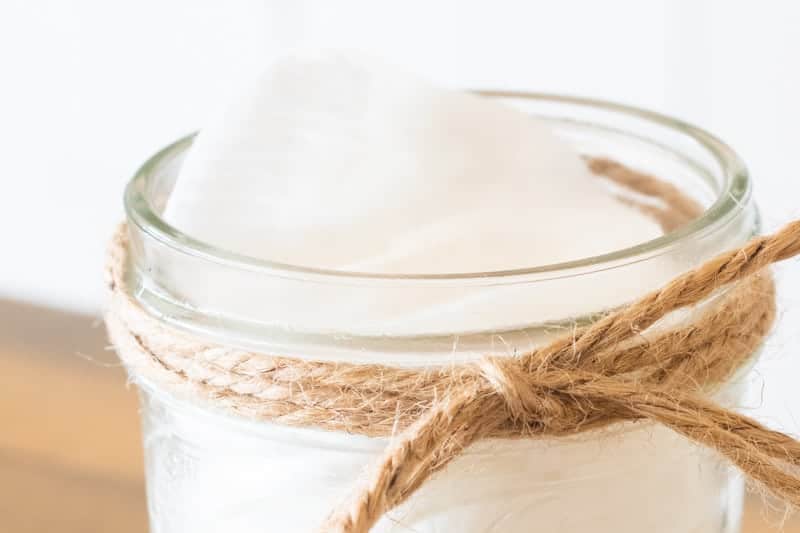 Mason jar with white cotton makeup remover wipes.