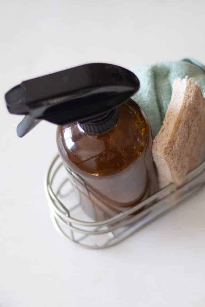 Homemade granite countertop cleaner in a metal basket.