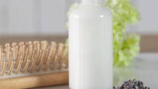 coconut milk leave-in conditioner in glass spray bottle