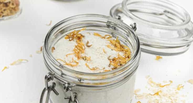 Oatmeal milk bath with dried flowers in mason jars.