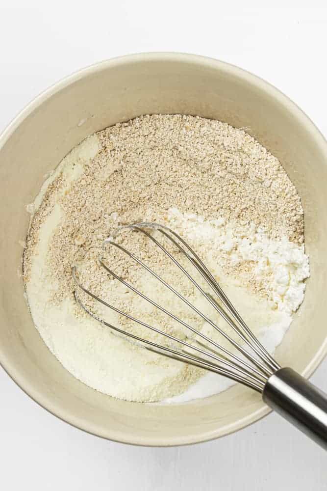 Tan bowl with whisk mixing powders.