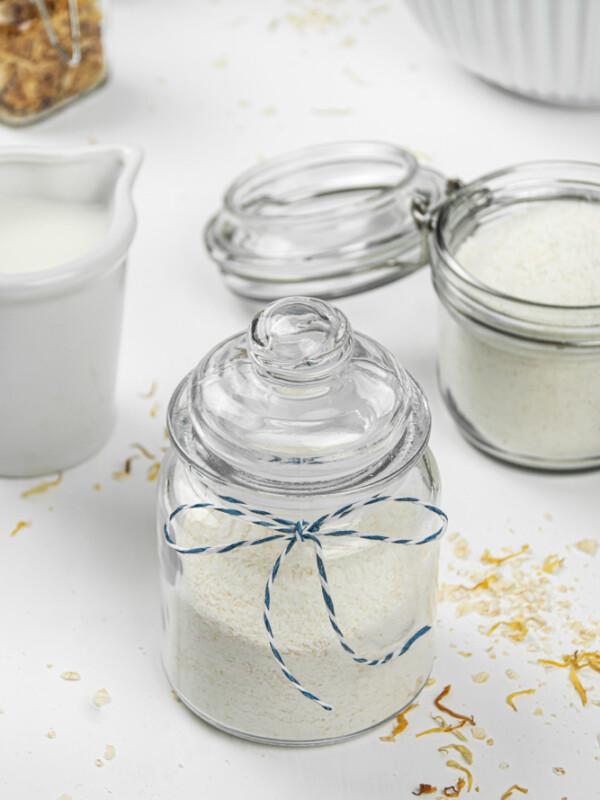 DIY oatmeal milk bath dried ingredients in a storage jar.