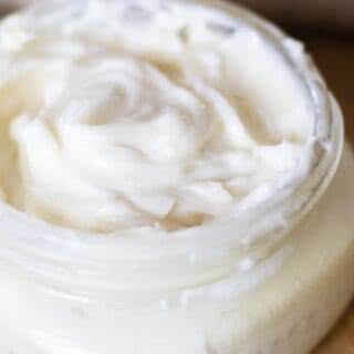 Homemade shaving cream in a shallow glass jar.