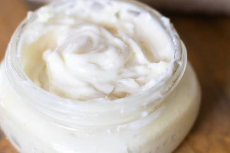 Homemade shaving cream in a shallow glass jar.