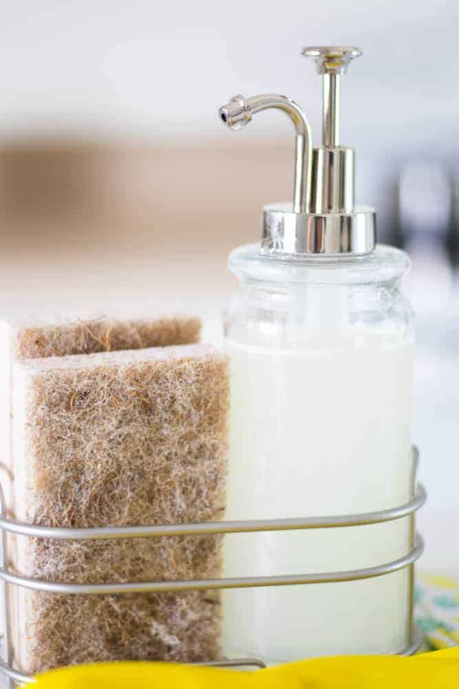 Tan dish sponge and soap in wire basket.