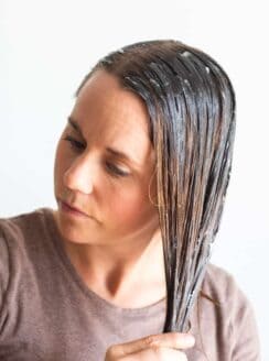 Women massaging hair mask into hair.