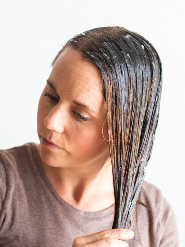 Women massaging hair mask into hair.