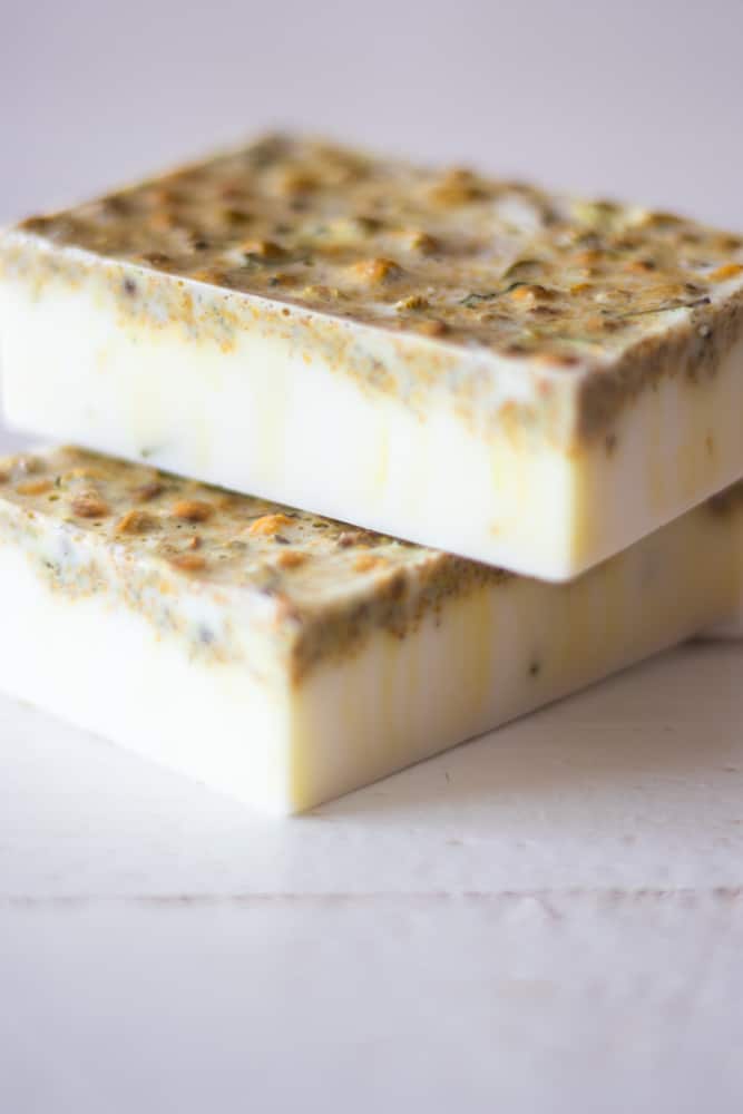 Two chamomile homemade soap bars stacked together with a white background.