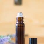 essential oil roller bottle in front of oil storage box