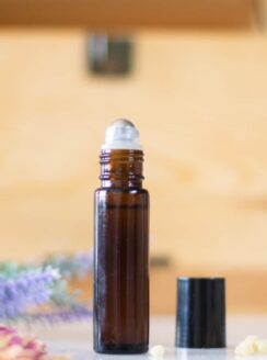 essential oil roller bottle in front of oil storage box