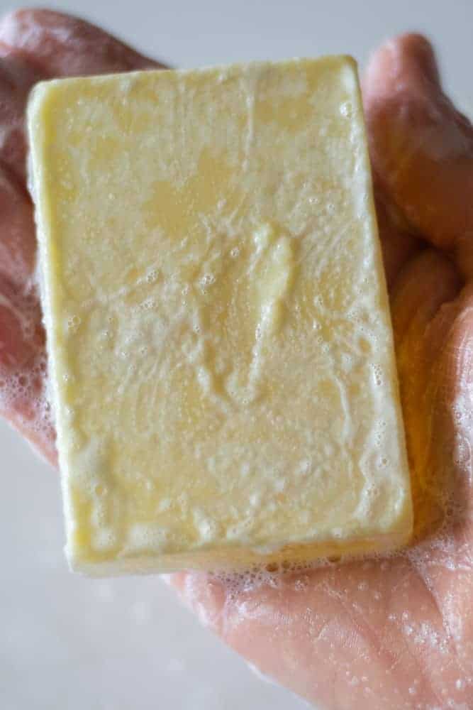 hand holding shampoo soap bar