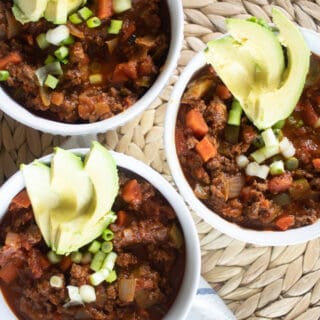 three bowls of whole30 chili on wicker background