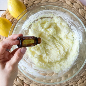 Adding lemon oil to mixture of garbage disposal cleaner.