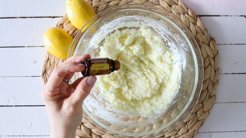 Adding drops of lemon essential oil to kitchen sink drain cleaner.