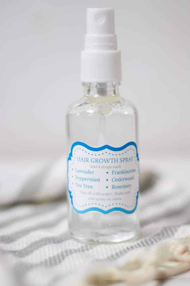 homemade hair growth spray with label on white background