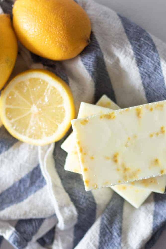 lemons and lemon dish soap bars on blue and white strip towel.