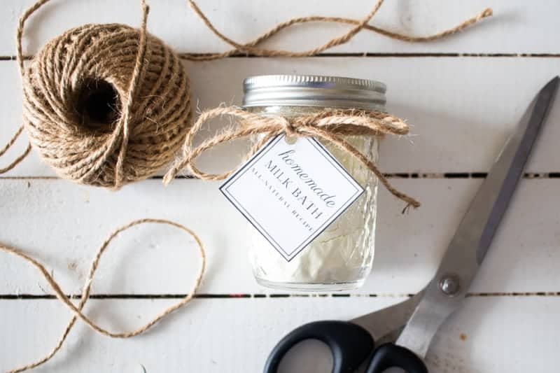 diy milk bath in mason jar with twine and label on white shiplap