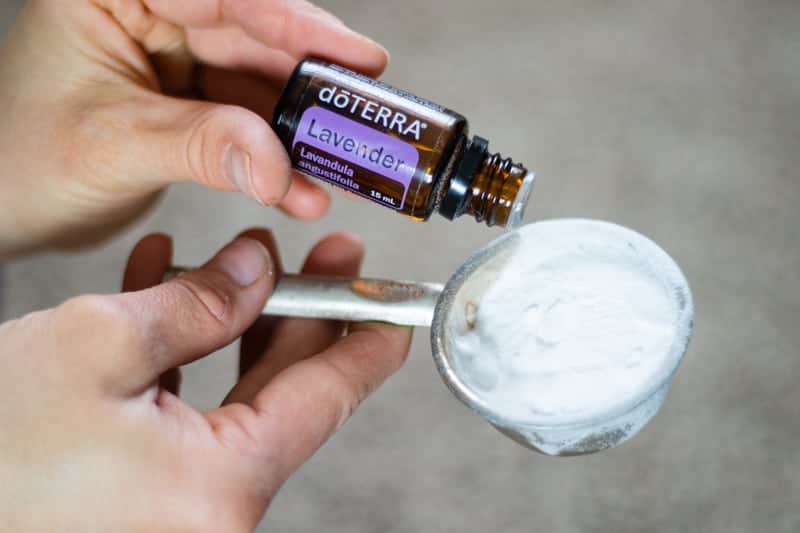 lavender drops into measuring cup of baking soda