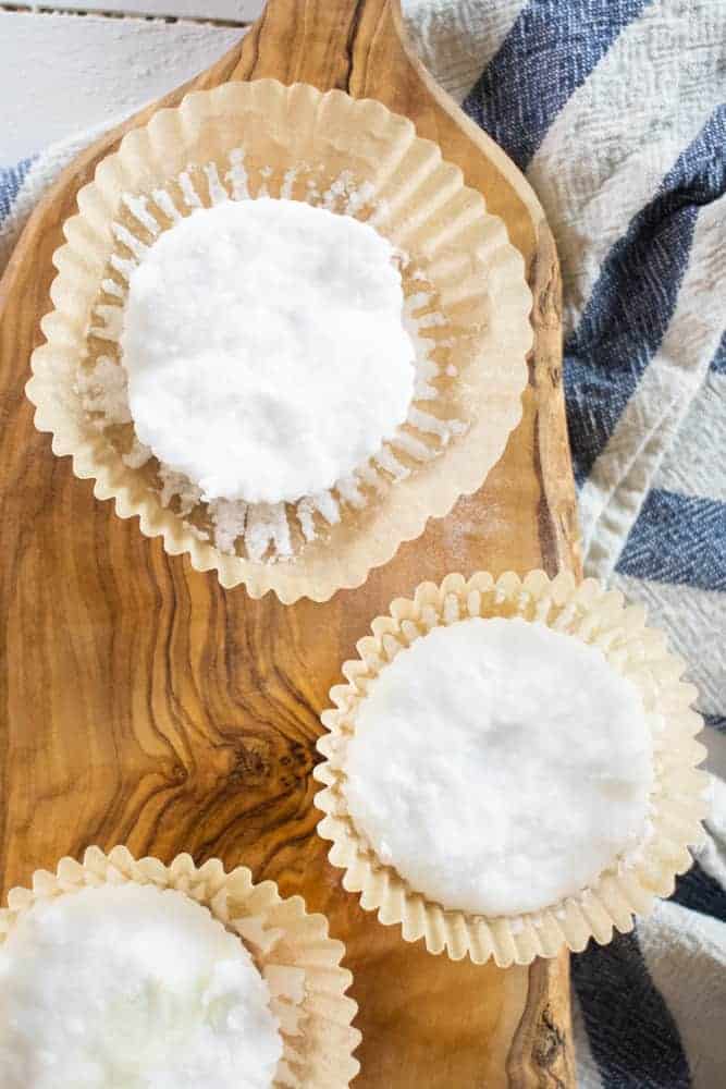 baking soda shower disk on wood cutting board