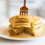 sourdough pancakes with maple syrup in white plate