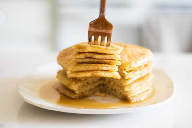 sourdough pancakes with maple syrup on white plate