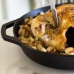 carving roasted whole chicken in cast iron skillet