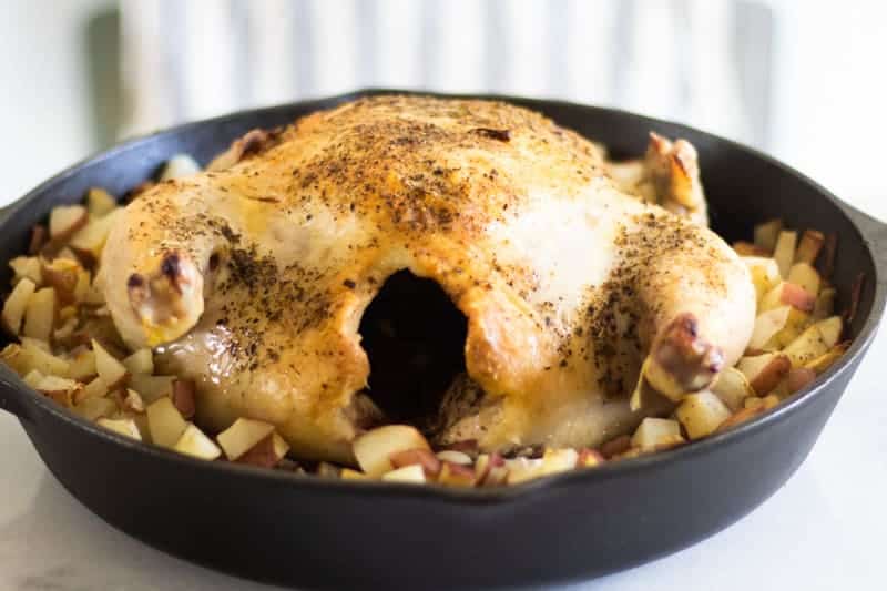 roasted chicken in cast iron skillet with chopped potatoes