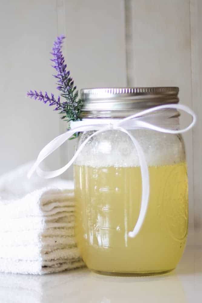 DIY bubble bath ingredients with a sprig of lavender