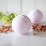 lavender bath bombs with rose petals around it