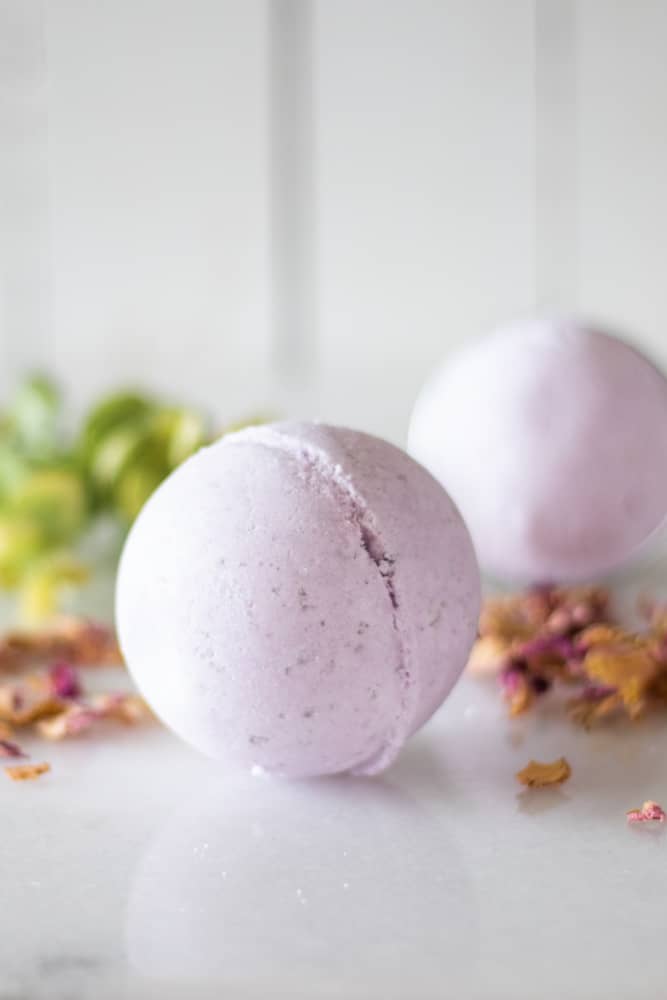 purple bath bombs on white marble