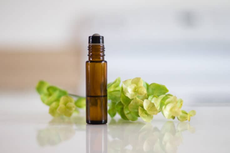 amber colored roller bottle with green plant