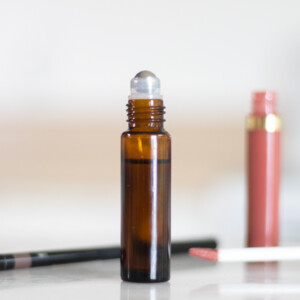 eyebrow roller bottle serum on white marble