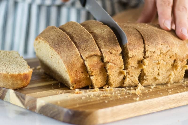 sliced homemade sourdough bread on wooden cutting board