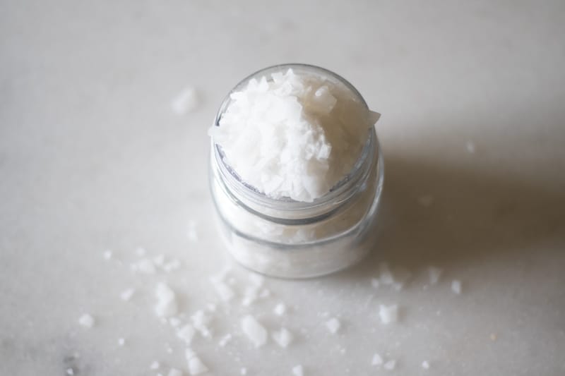 magnesium flakes in mason jar on white marble