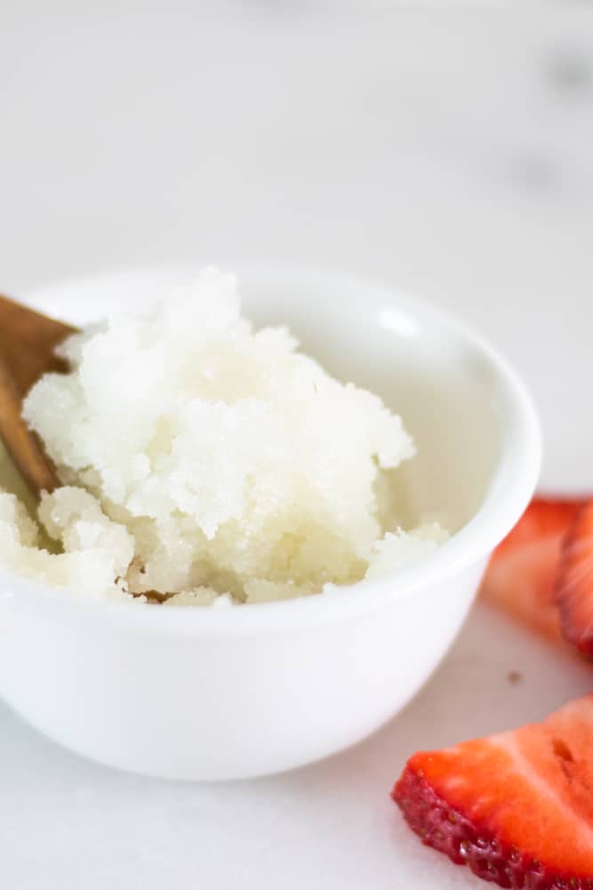 homemade sugar scrub being scooped from a small bowl