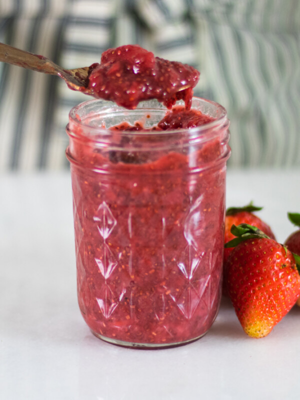Healthy strawberry jam in a glass mason jar.