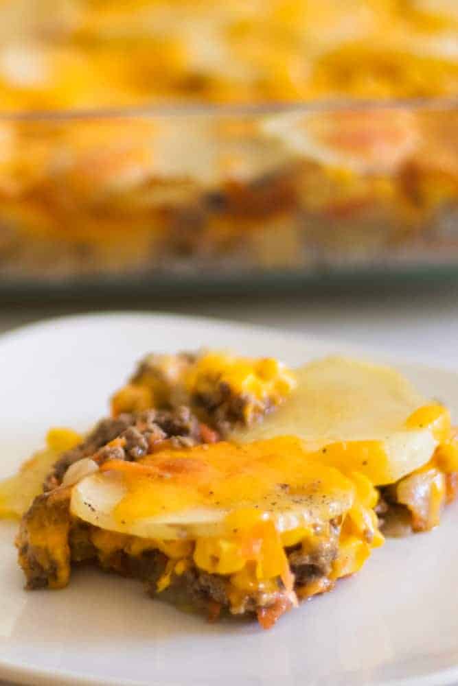 cheesy hamburger casserole on white square plate