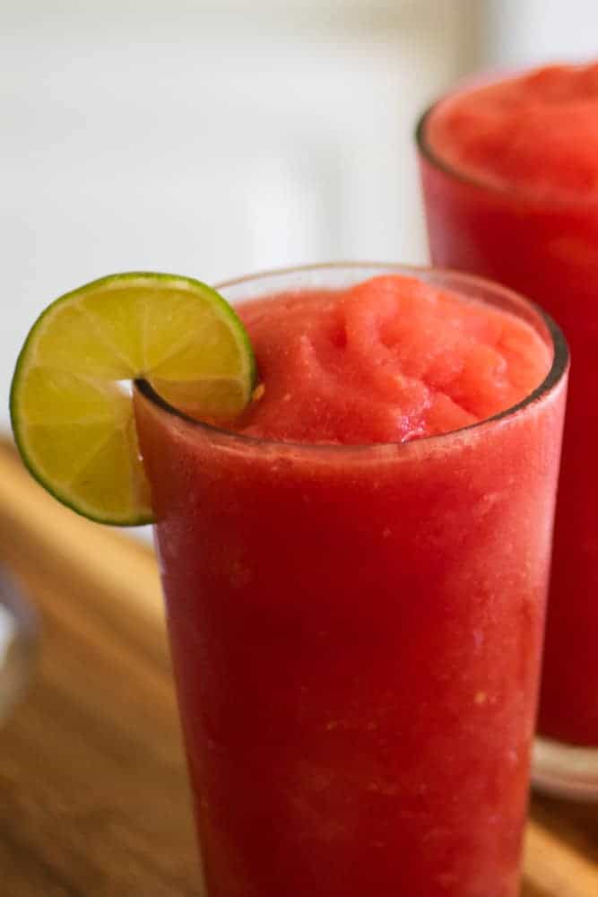 watermelon slushy in glass with lime slice