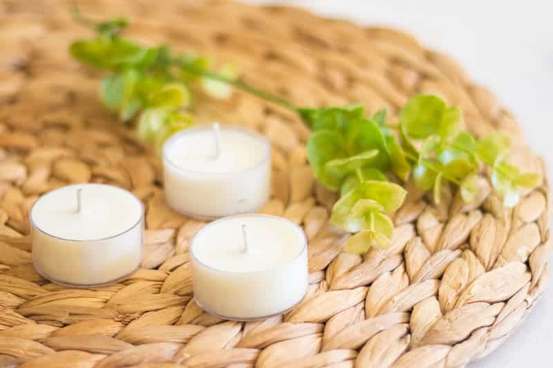 tea light candles for bugs on wicker placemat.