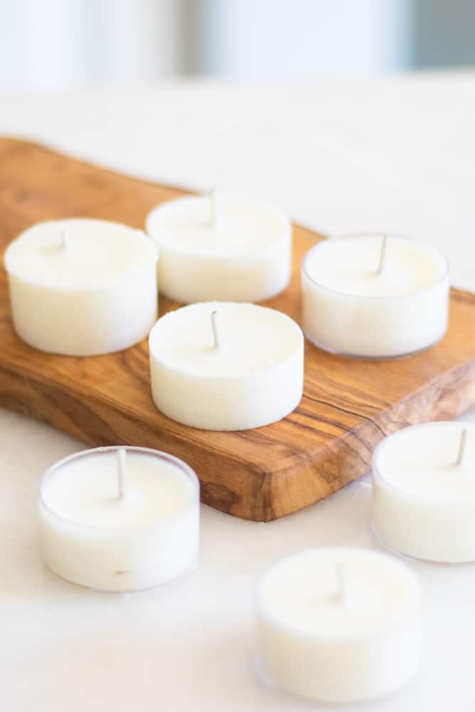 homemade citronella candles on wooded cutting board.