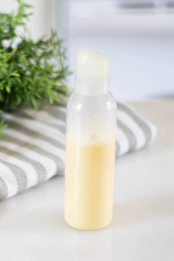 homemade coconut milk shampoo in clear plastic bottle