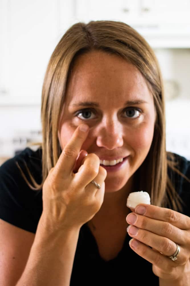 woman applying homemade eye cream under eye