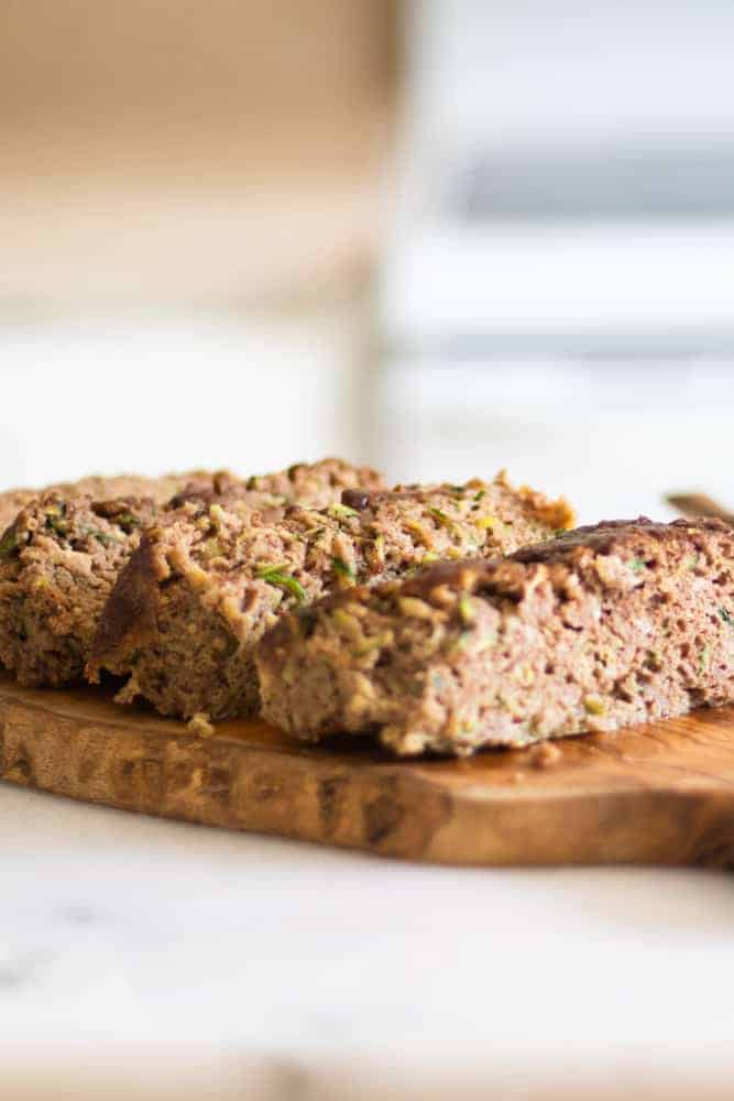 sliced paleo zucchini bread on wooden cutting board