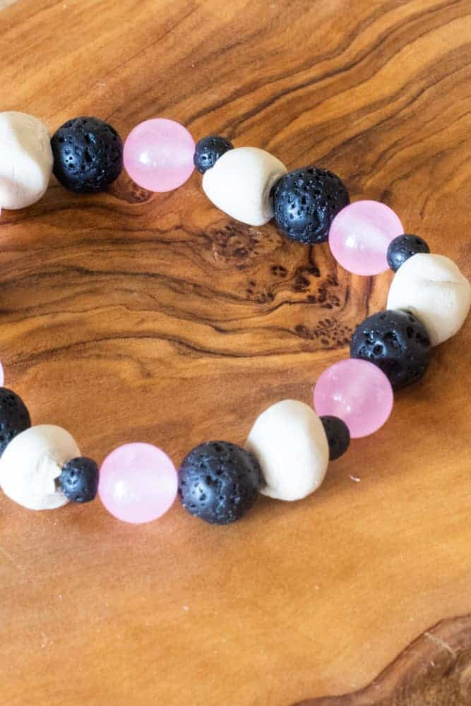 essential oil diffuser bracelet on wood board