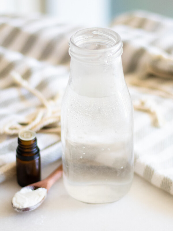 Homemade mouthwash in glass container.