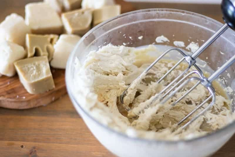 Mixing mango butter and cocoa butter on wooden table