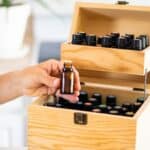 women pulling essential oil out of wooden oil storage box