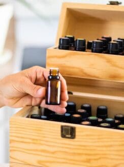 women pulling essential oil out of wooden oil storage box