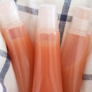 diy lip gloss on white and blue towel